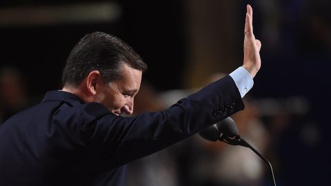 US Senetor Ted Cruz waves from the stage at the Republican National Convention at the Quicken Loans Arena in Cleveland, Ohio on July 20, 2016. The cost of the convention for the Republican Party will run some $64 million. The number of visitors expected in Cleveland is 50,000, including 15,000 journalists and 2,472 delegates (there are also 2,302 alternate delegates.) / AFP PHOTO / Robyn BECK