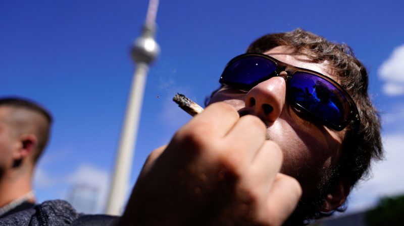 Berlin, 2018. augusztus 11. Egy résztvevõ dohányzik az indiai vadkender legalizásáért rendezett kannabisz felvonuláson a berlini tévétoronynál 2018. augusztus 11-én. (MTI/EPA/Alexander Becher)