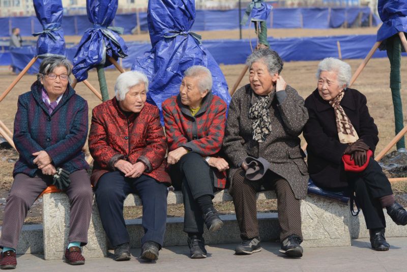 --FILE--Elderly Chinese women chat on a bench at Beishan Park in Jilin city, northeast China's Jilin province, 16 March 2016. The average life expectancy in China in 2015 was 76.34, an increase of 1.51 years from 2010, according to statistics released Thursday (21 July 2016). The infant mortality rate dropped from 0.89 percent in 2014 to 0.81 percent in 2015, while the maternal mortality rate lowered from 21.7 in every 100,000 in 2014 to 20.1 in 2015, according to the statistical bulletin released by the National Health and Family Planning Commission (NHFPC). In 2015, personal health costs for Chinese residents fell by 2.02 percentage points year on year, accounting for 29.97 percent of the country's total health expenditure, which stood at 4 trillion yuan (US$608 billion), the bulletin showed.