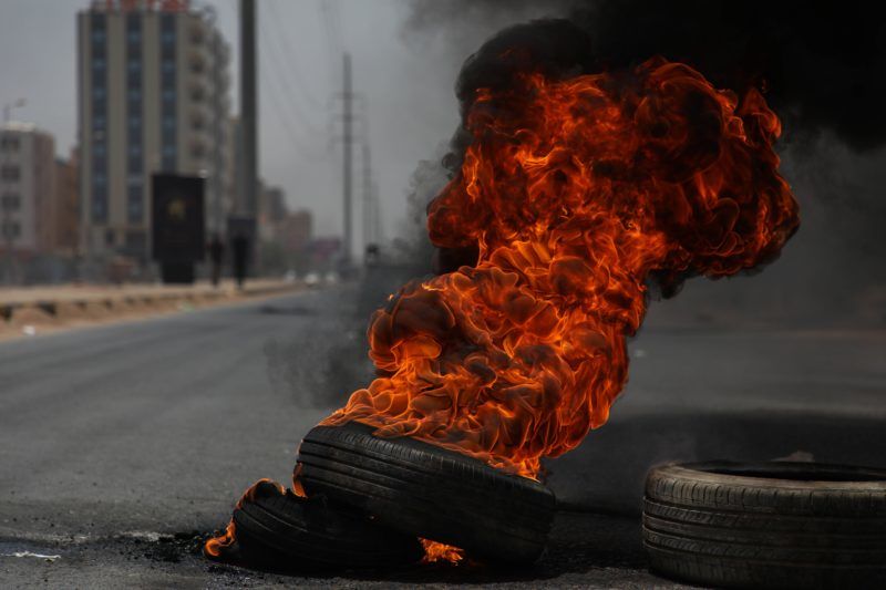 KHARTOUM, SUDAN - JUNE 03 : Sudanese protesters burn tyres and set up barricades on roads to army headquarters after the intervention of Sudanese army, during a demonstration in Khartoum, Sudan on June 3, 2019. At least 13 protesters were killed and hundreds injured on Monday as Sudanese security forces moved in to clear the main protest camp near the army headquarters in the capital Khartoum, according to protest organizers. Mahmoud Hjaj / Anadolu Agency