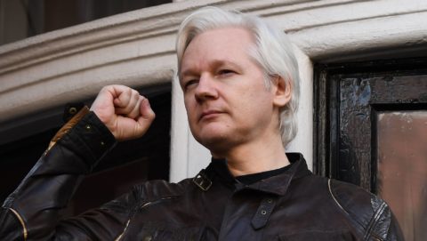 Wikileaks founder Julian Assange raises his fist prior to addressing the media on the balcony of the Embassy of Ecuador in London on May 19, 2017. Ecuador urged Britain today to 