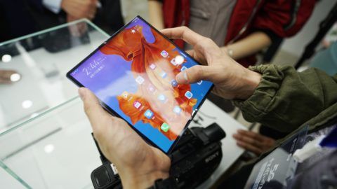 A Chinese employee shows 5G wireless network on a Huawei Mate X, the first 5G foldable smartphone of Huawei, at the first experience area featuring 5G wireless network in Hangzhou city, east China's Zhejiang province, 17 April 2019. The first experience area featuring 5G wireless network opened to the public in Hangzhou, Zhejiang province, on April 5, offering locals a glimpse at the next-generation technology. The area aims to provide a taste of what's in store with 5G network, featuring autonomous vehicles, virtual reality and a robot that claims to be unbeatable at rock-paper-scissors  thanks to an artificial intelligence algorithm and 5G technologies which allow it to predict its opponent's move based on hand gestures. With a higher speed and lower latency, 5G network has a peak download speed of 2.8 Gbps, about 10 times that of 4G.