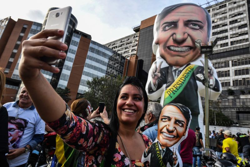 Supporters of Brazilian right-wing presidential candidate Jair Bolsonaro gather on September 16, 2018 in front of the Israelita Albert Einstein Hospital in Sao Paulo, Brazil, after it was announced that their stabbed leader left the intensive care unit. Brazil presidential election front-runner Bolsonaro was stabbed by a left-wing activist on September 6 during a campaign rally in the southern state of Minas Gerais. / AFP PHOTO / Nelson ALMEIDA